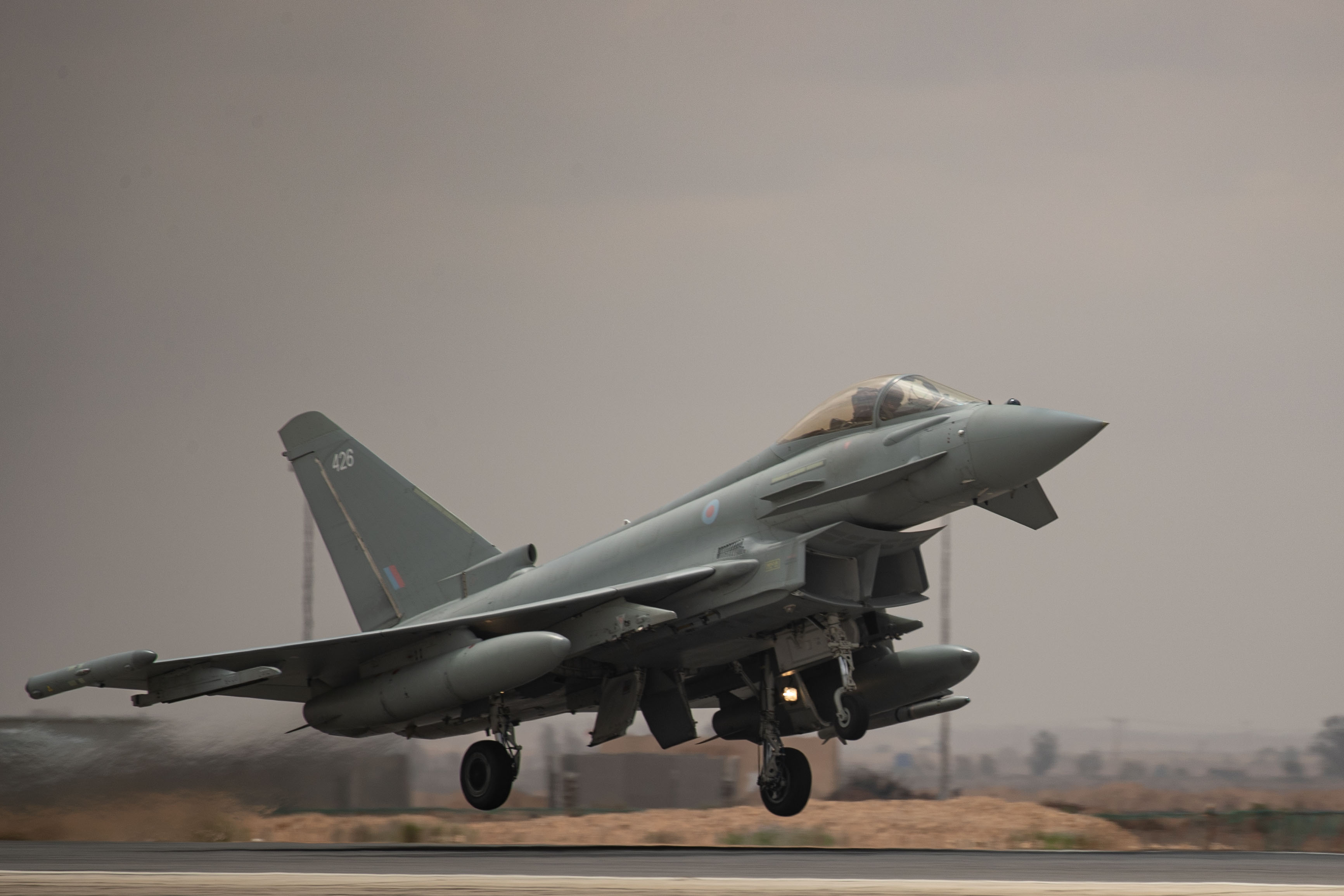 Image shows RAF Typhoon taking off from the airfield.